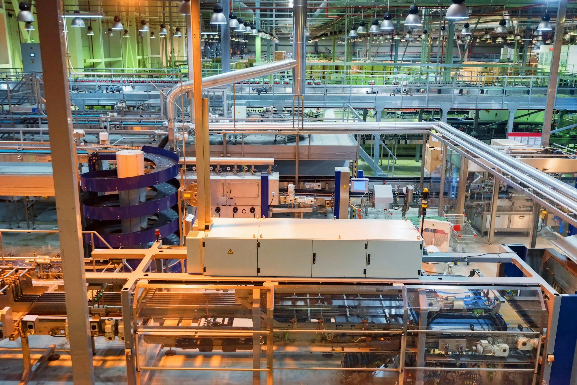Industrial interior of soft drinks factory with tubes