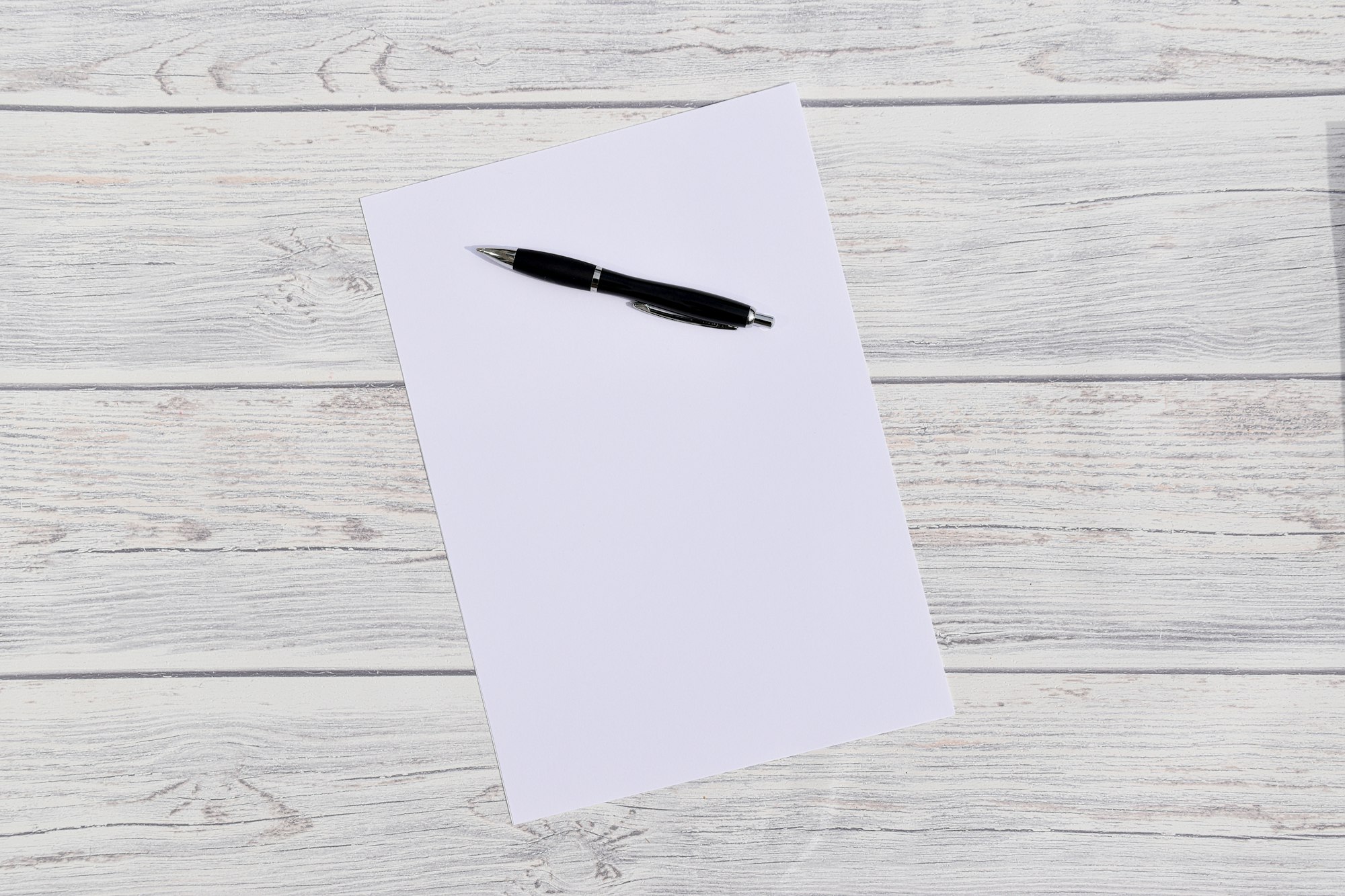 pen and paper on wooden background